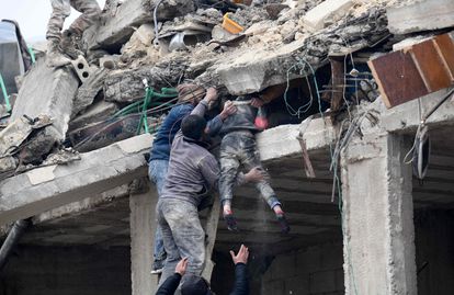 Residentes rescataban a una niña de un edificio colapsado en la ciudad siria de Jandaris.